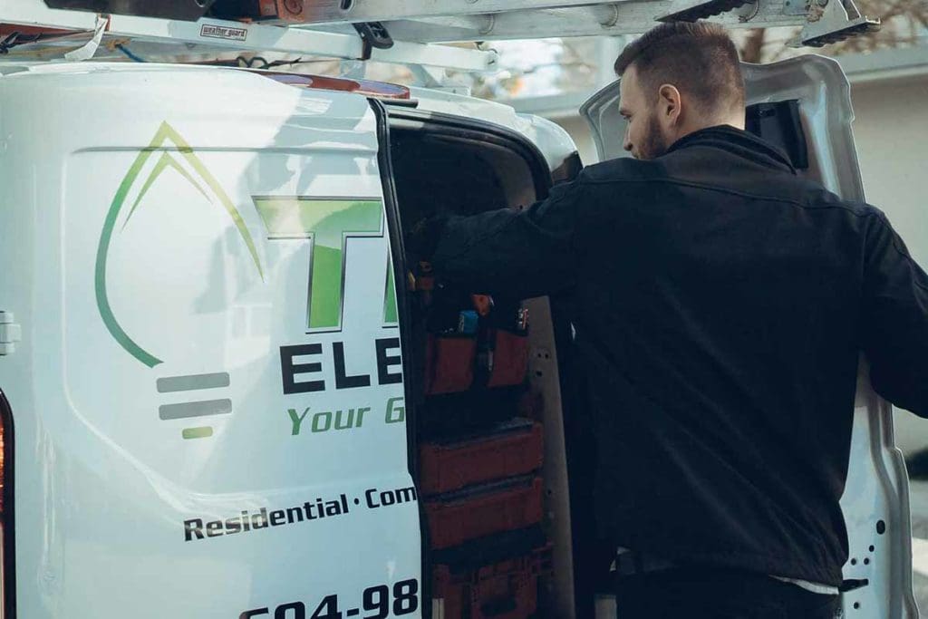 TDR electrician taking tools out of back of TDR electric truck